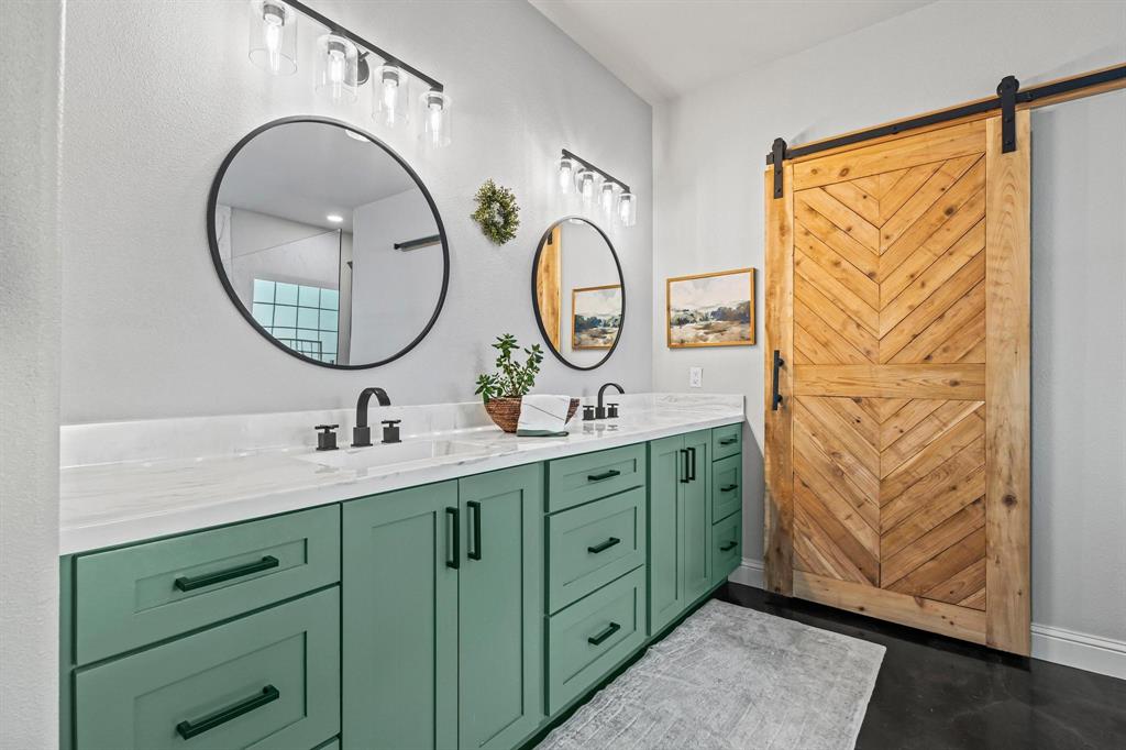 979 Mitchell Road Sherman, TX 75090 - Photo 18 of 40 Bathroom with double vanity and baseboards