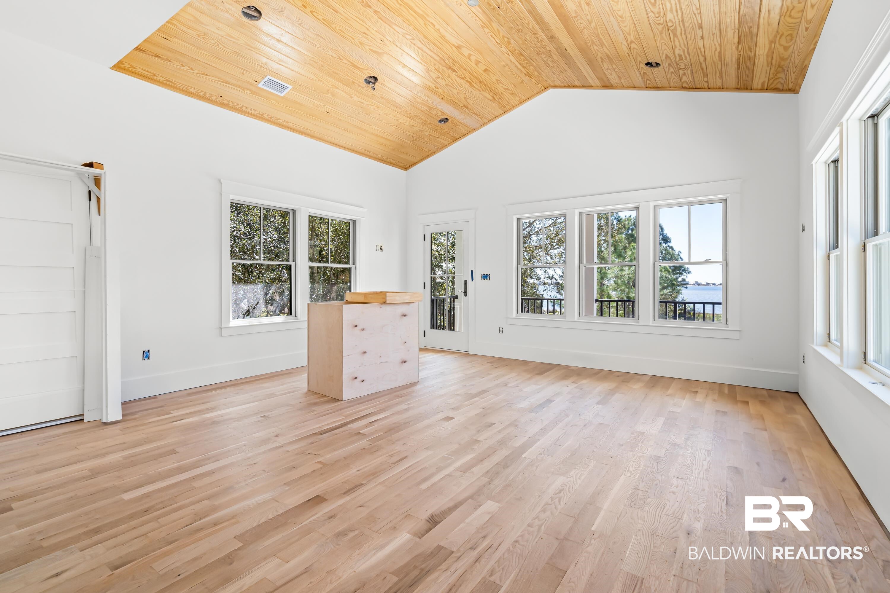 14686 State Highway Gulf Shores, AL 36542 - Photo 7 of 44 Unfurnished living room with light wood-style flooring, wood ceiling, plenty of natural light, and visible vents