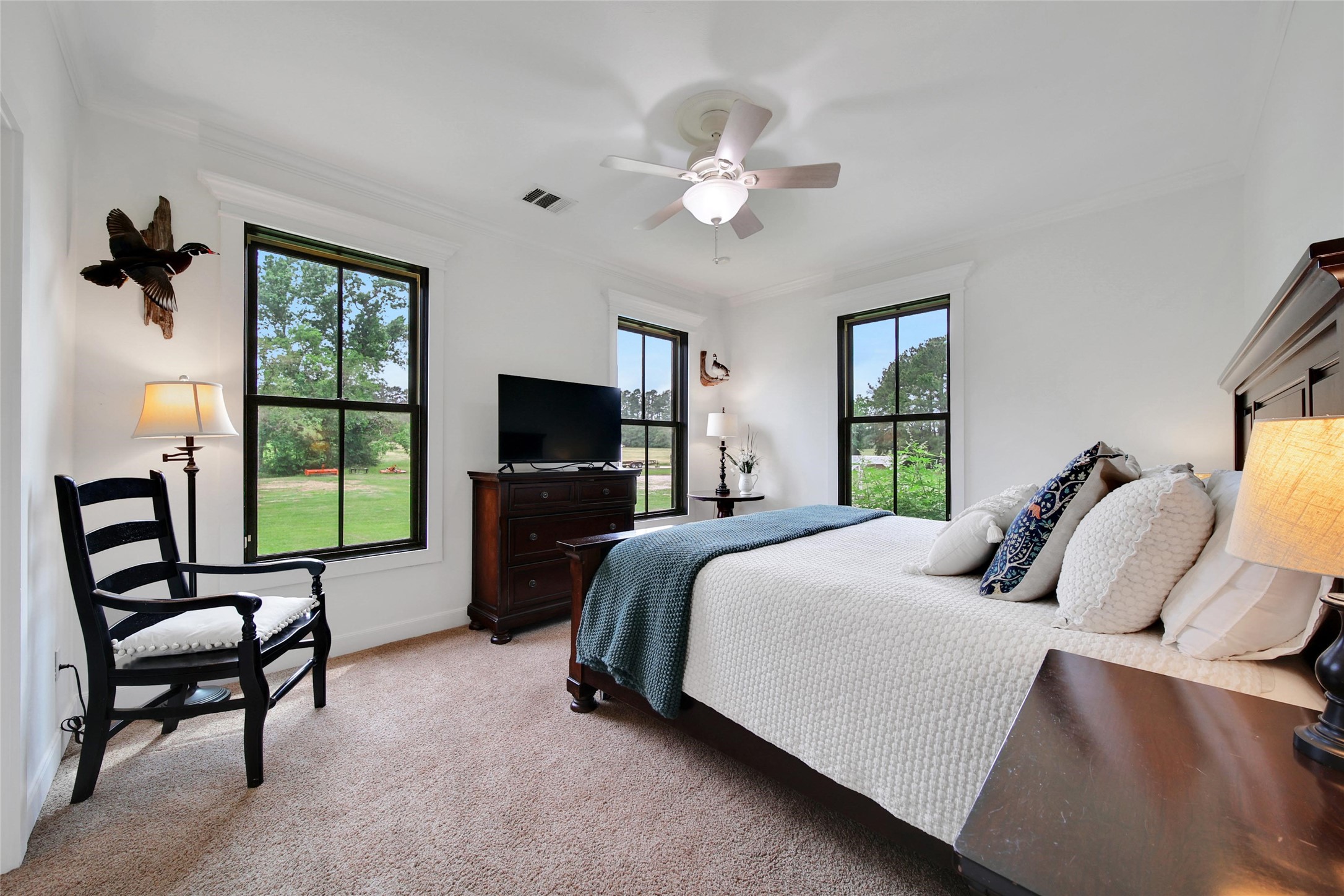 18875 Rabon Chapel Road Montgomery, TX 77316 - Photo 22 of 45 a bedroom with a bed and a flat screen tv