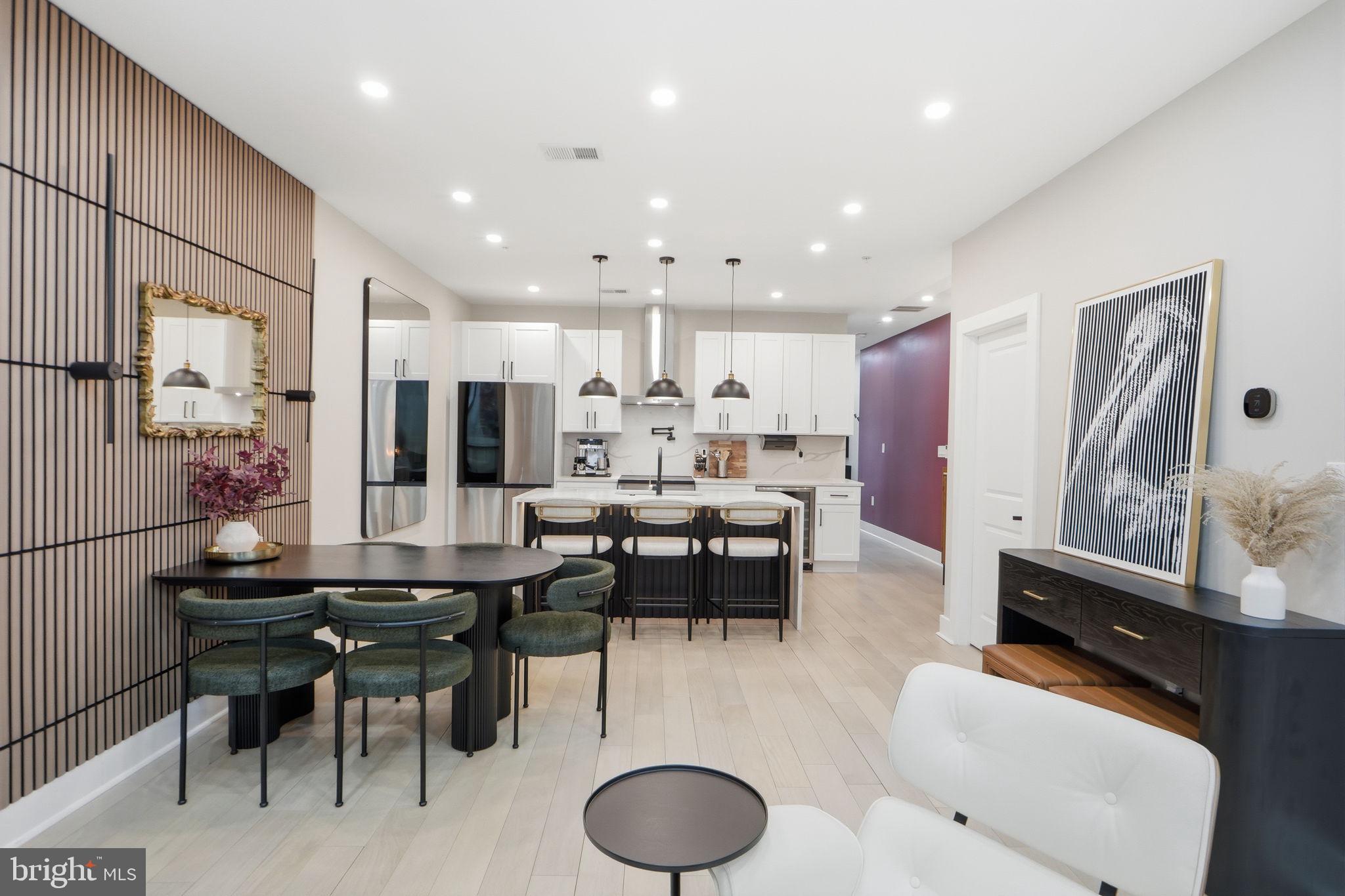 533 Shepherd Street Northwest Washington, DC 20011 - Photo 16 of 69 a kitchen with stainless steel appliances kitchen island granite countertop a dining table chairs and a refrigerator