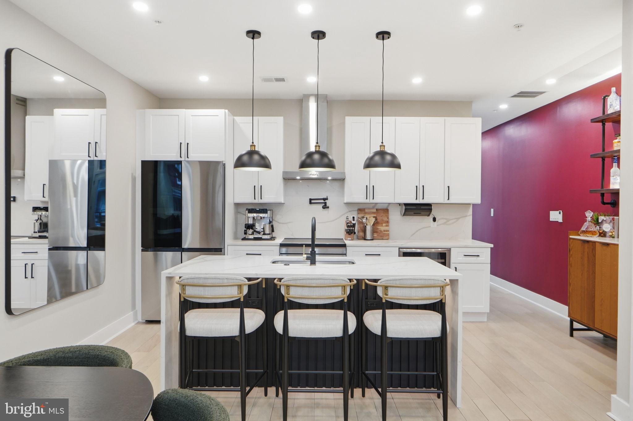 533 Shepherd Street Northwest Washington, DC 20011 - Photo 18 of 69 a kitchen with stainless steel appliances kitchen island granite countertop a dining table chairs and white cabinets