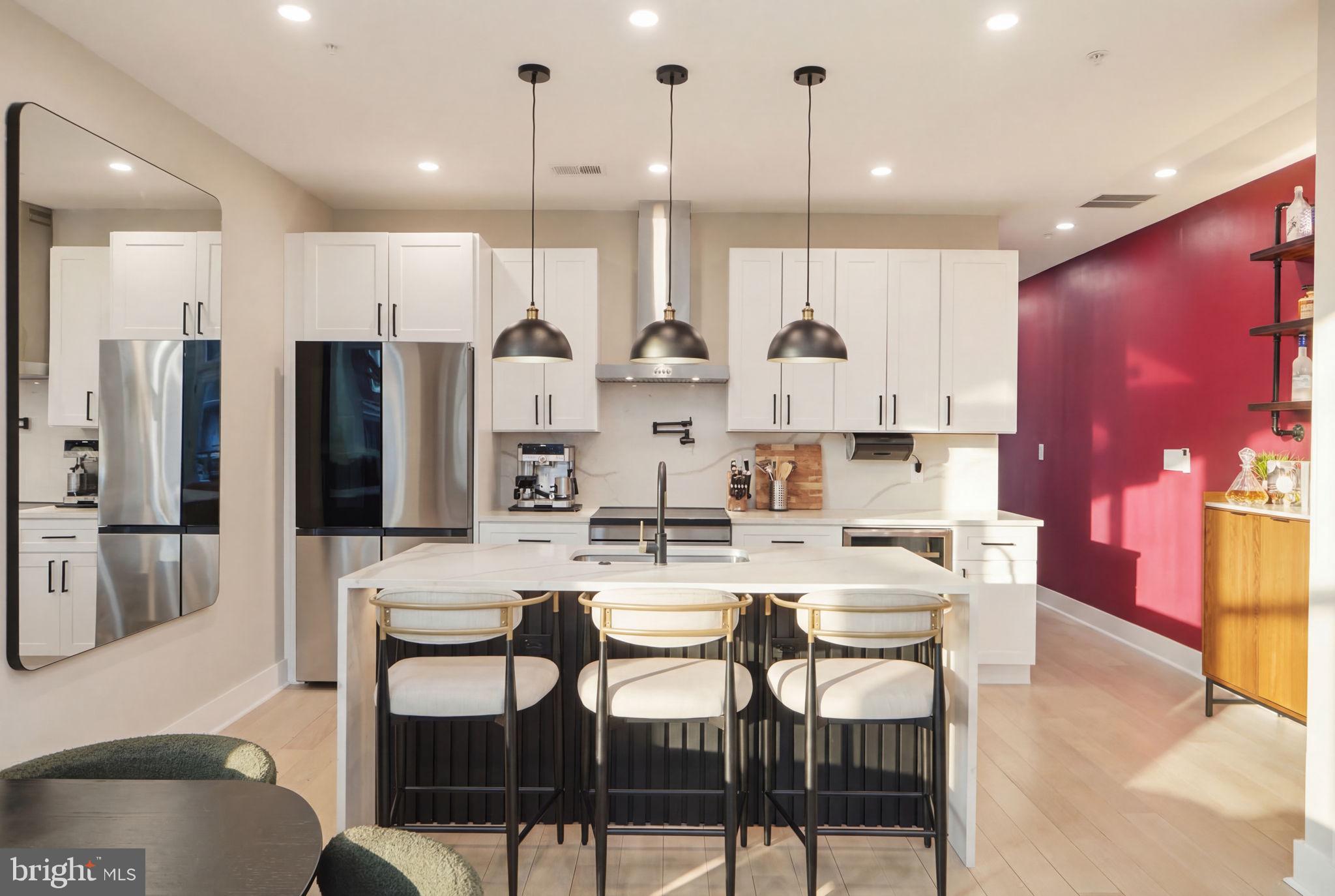 533 Shepherd Street Northwest Washington, DC 20011 - Photo 19 of 69 a kitchen with stainless steel appliances kitchen island granite countertop a kitchen island and chairs in it