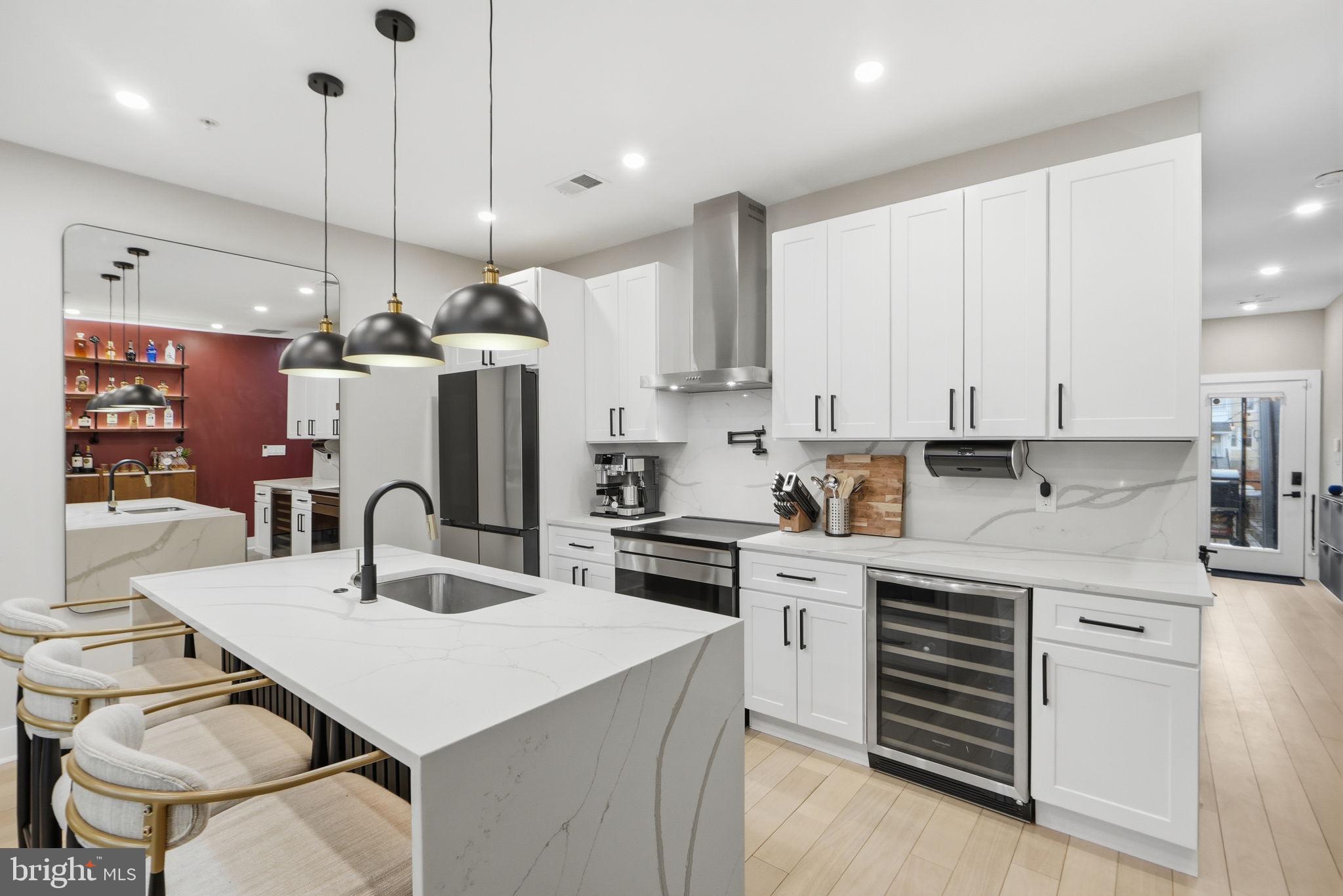 533 Shepherd Street Northwest Washington, DC 20011 - Photo 20 of 69 a kitchen with stainless steel appliances granite countertop a sink a stove a refrigerator and island with wooden floor