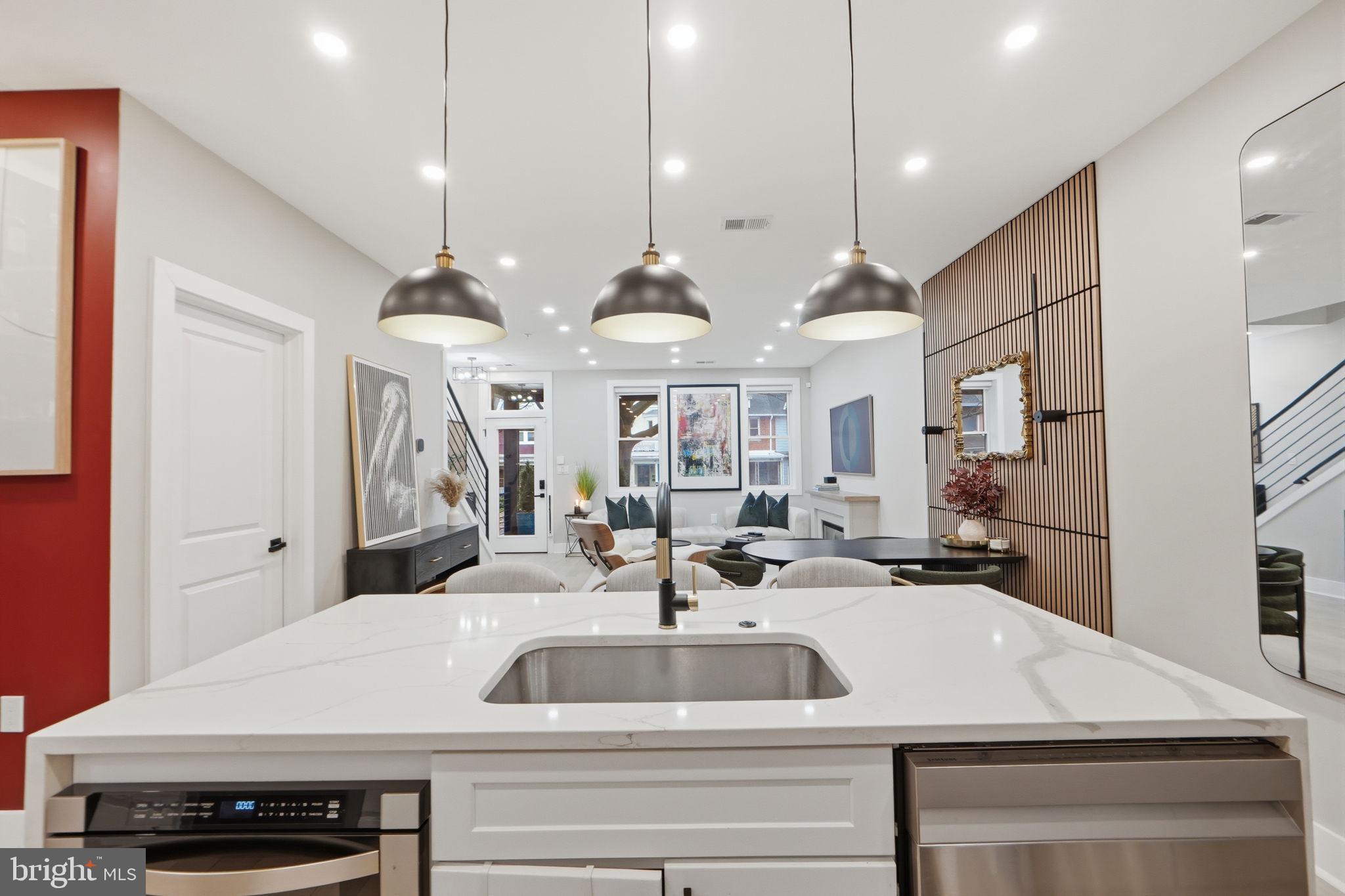 533 Shepherd Street Northwest Washington, DC 20011 - Photo 22 of 69 a kitchen with stainless steel appliances kitchen island a white counter space a sink and chairs