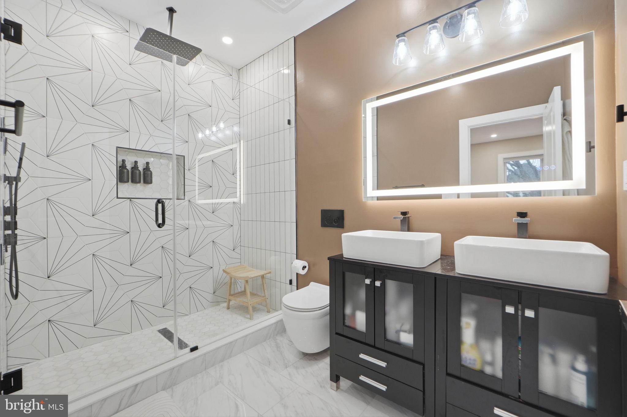 533 Shepherd Street Northwest Washington, DC 20011 - Photo 30 of 69 a bathroom with a double vanity sink toilet and shower