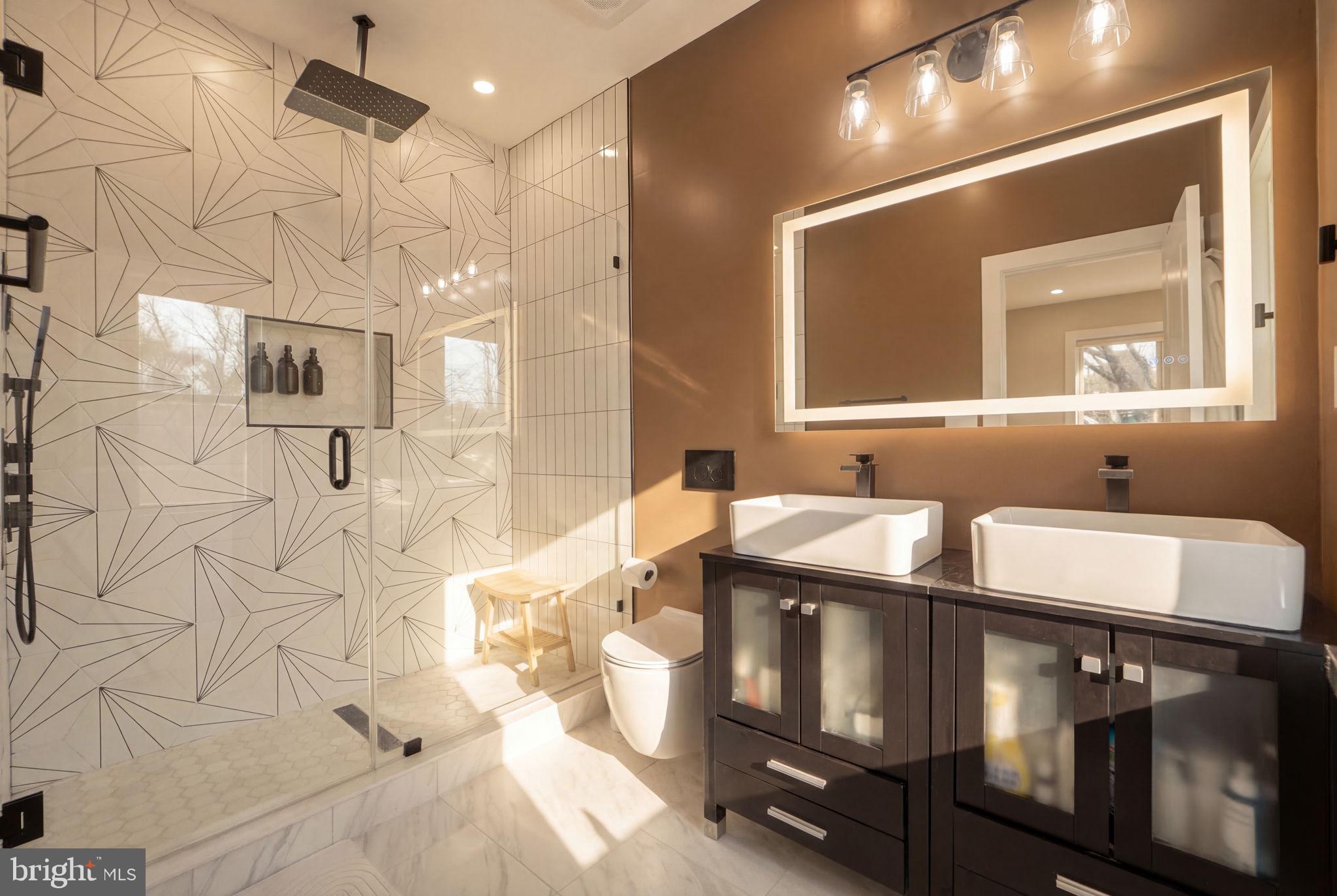 533 Shepherd Street Northwest Washington, DC 20011 - Photo 31 of 69 a kitchen with stainless steel appliances kitchen island granite countertop a table chairs in it and wooden floors