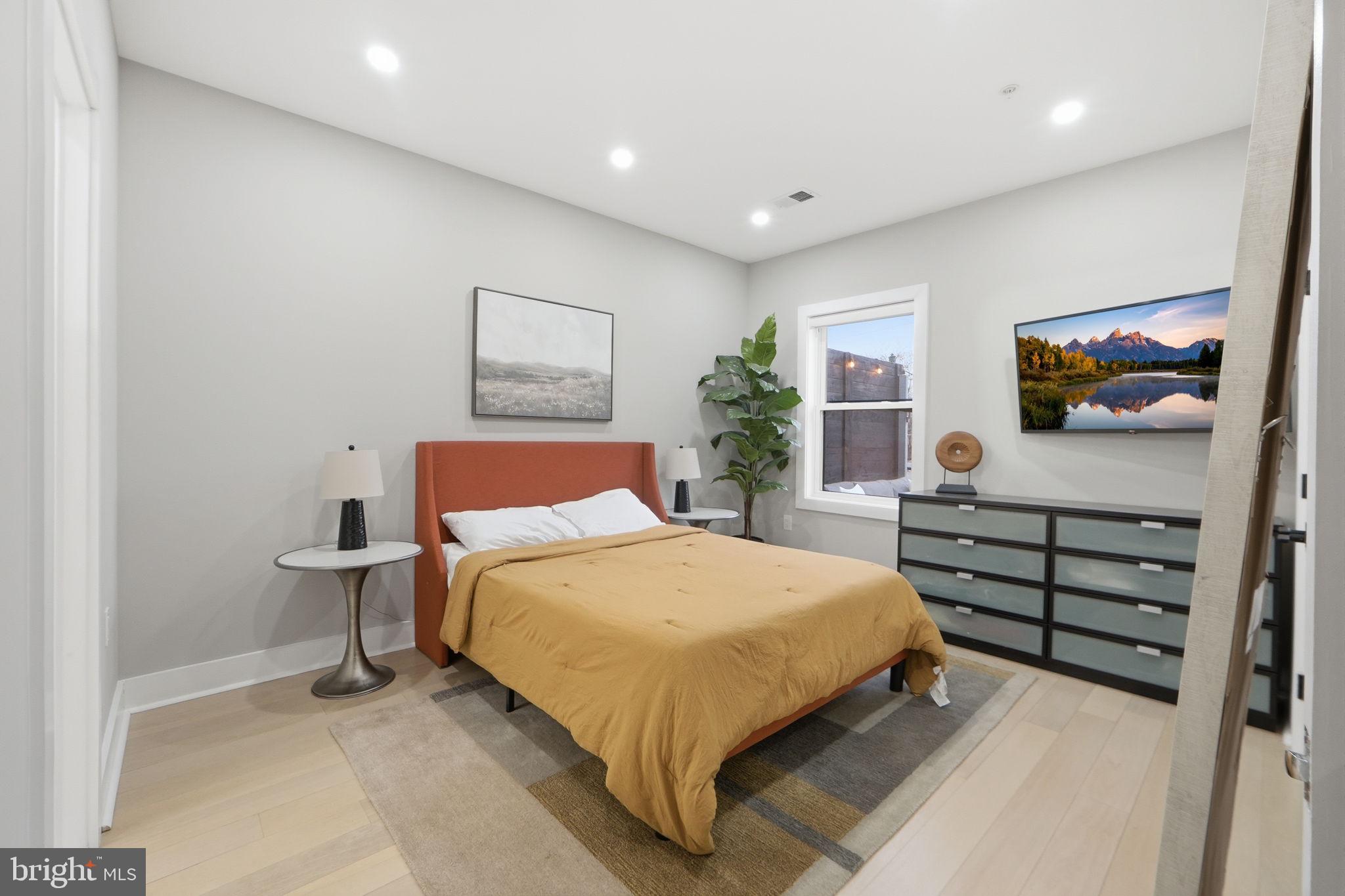 533 Shepherd Street Northwest Washington, DC 20011 - Photo 32 of 69 a bedroom with a bed and a flat screen tv