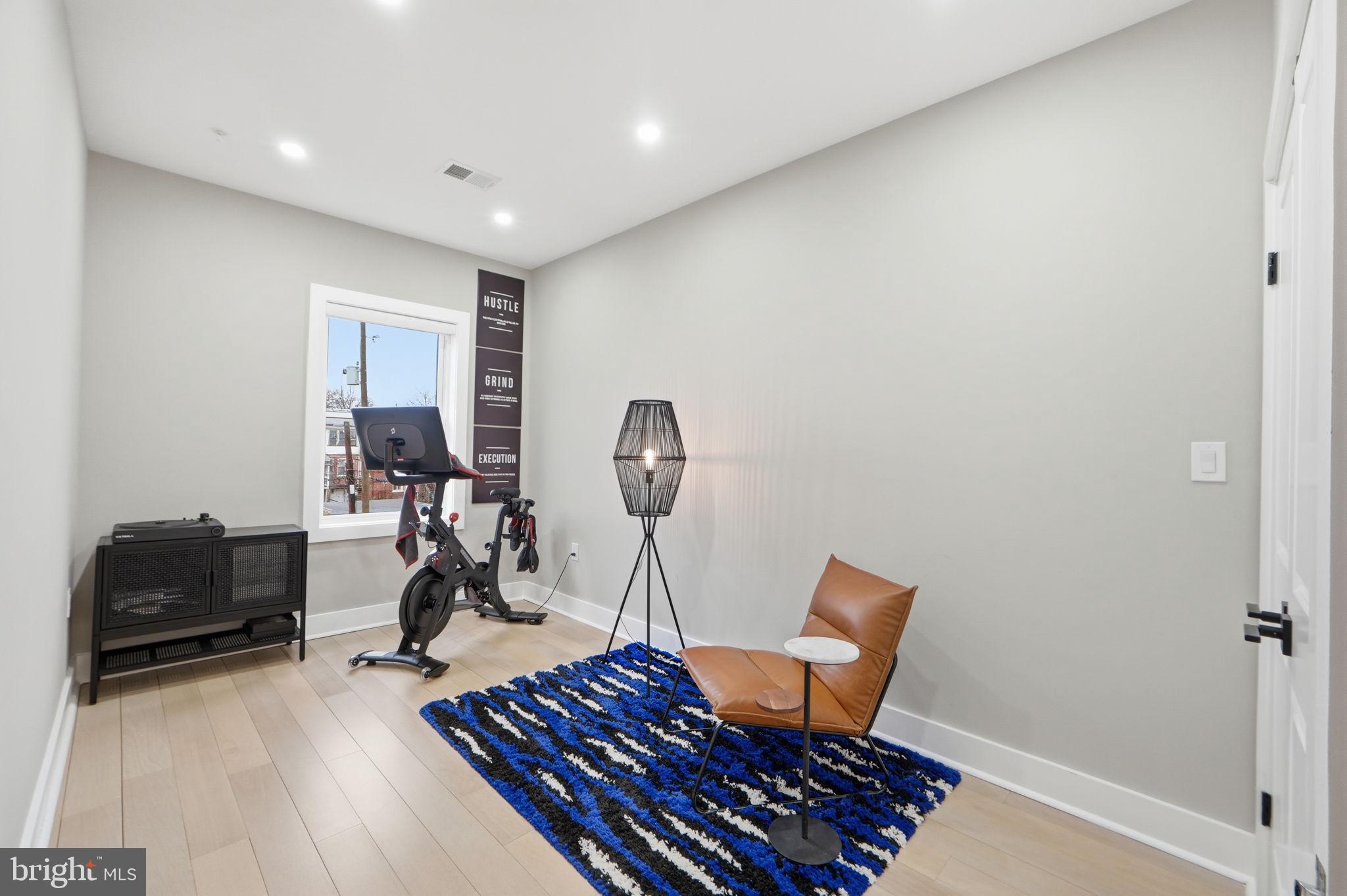 533 Shepherd Street Northwest Washington, DC 20011 - Photo 39 of 69 a view of a workspace with furniture and gym equipment