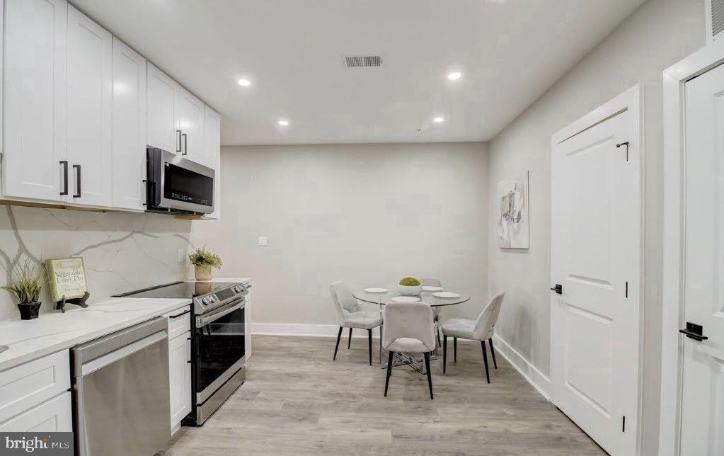 533 Shepherd Street Northwest Washington, DC 20011 - Photo 50 of 69 a kitchen with a table and chairs in it