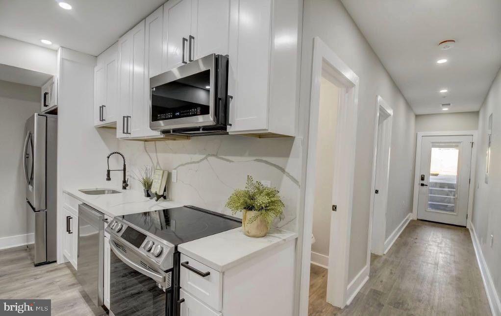 533 Shepherd Street Northwest Washington, DC 20011 - Photo 52 of 69 a kitchen with stainless steel appliances a microwave a sink and a refrigerator