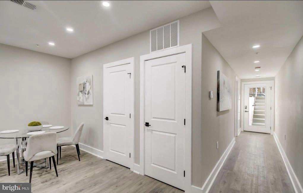 533 Shepherd Street Northwest Washington, DC 20011 - Photo 53 of 69 a view of a hallway to dining room with wooden floor and furniture