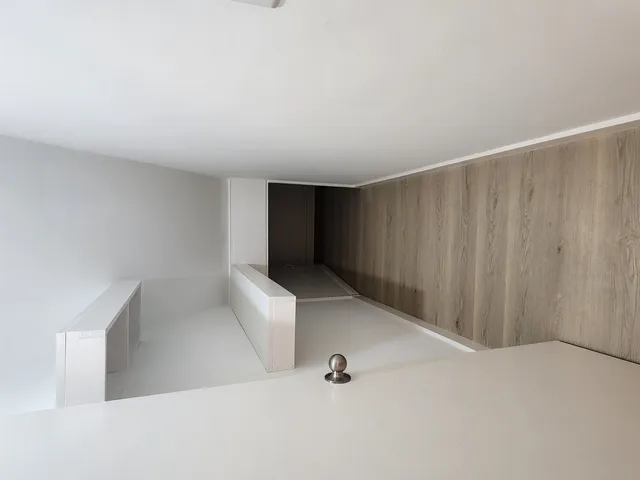 a view of an empty room with windows