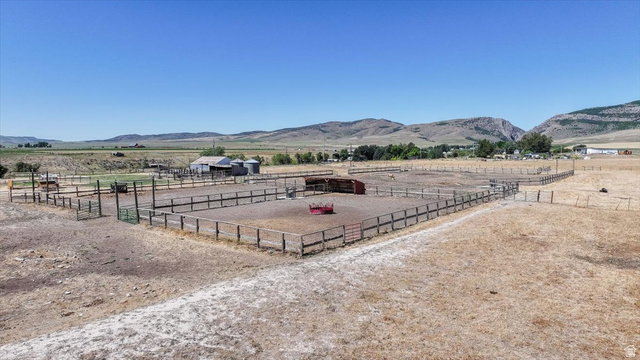 1634 West Arimo Road Arimo, ID 83214 - Photo 75 of 89 Extensive fenced paddocks and corrals with multiple gates, a barn structure, and two grain silos
