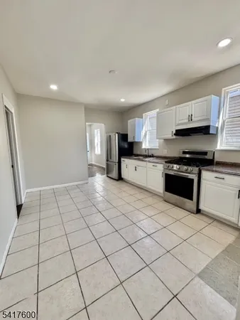 a kitchen with stainless steel appliances a sink a stove a microwave and cabinets
