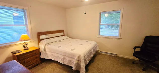 a bedroom with a bed and a window