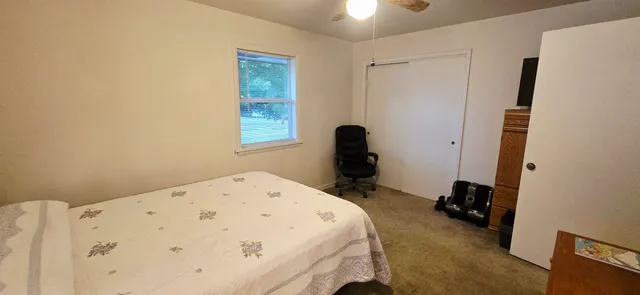 a white toilet sitting next to a bathroom sink and a granite floor