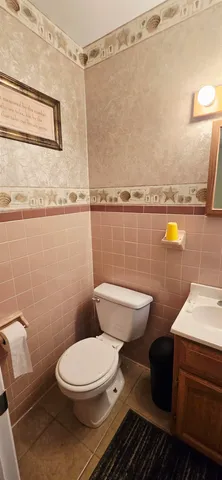 a bathroom with a sink toilet and mirror