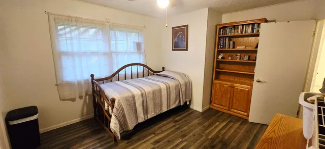 a hallway with a flat screen tv and couches
