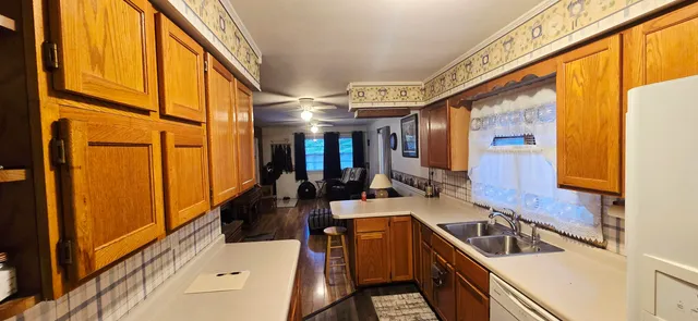 a kitchen with stainless steel appliances granite countertop a sink dishwasher stove and refrigerator
