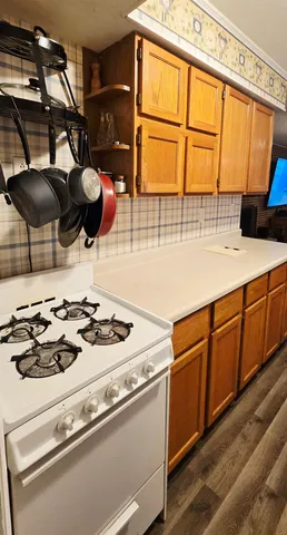 a kitchen with a stove a sink and a microwave