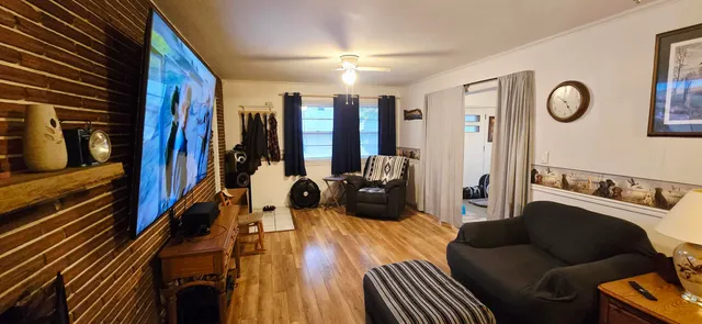 a living room with furniture and a flat screen tv