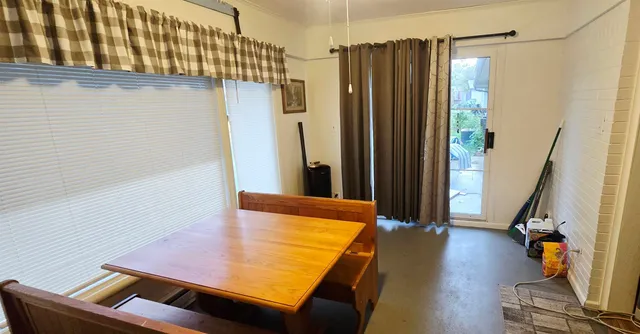 a living room with furniture and a mirror