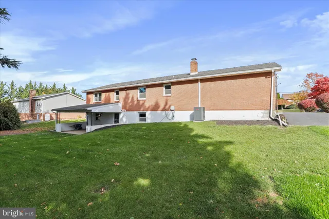 a view of a house with a backyard and a patio
