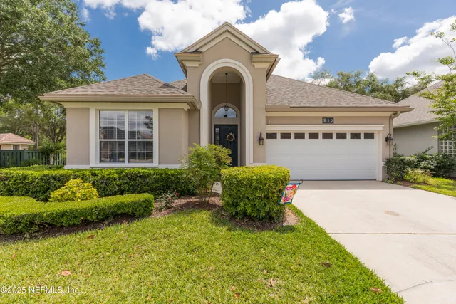 a front view of a house with garden