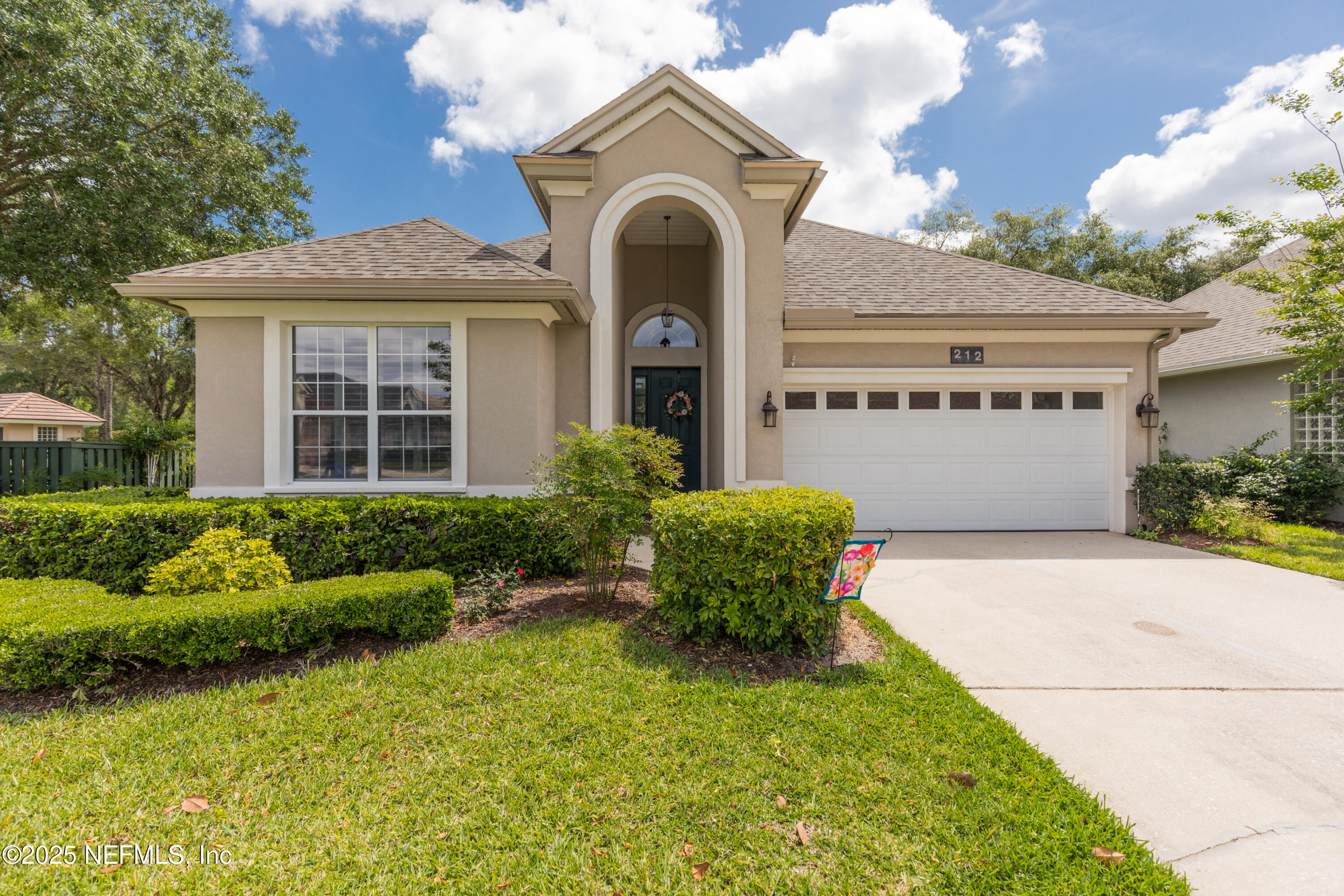 a front view of a house with garden