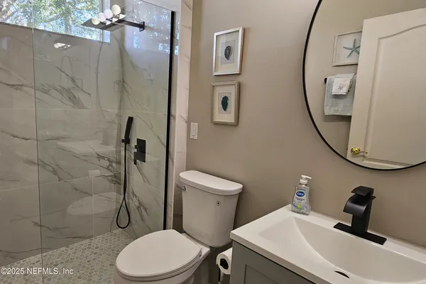 a bathroom with a toilet and a shower