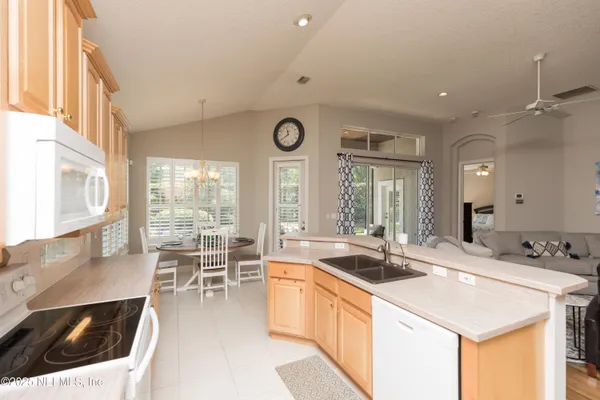 a kitchen with stainless steel appliances a stove a sink and a refrigerator