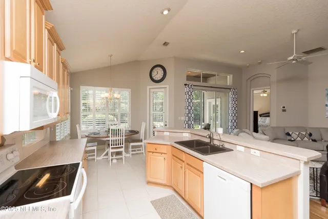 a kitchen with stainless steel appliances a stove a sink and a refrigerator