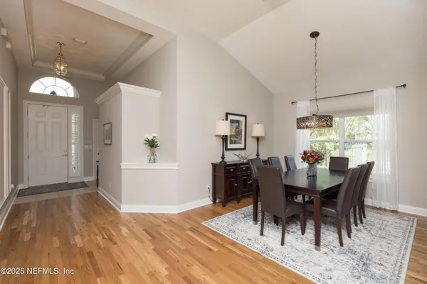 a dining room with furniture and chandelier