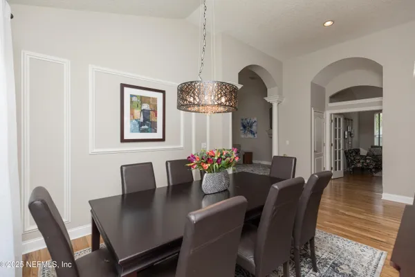 a view of a dining room with furniture window and wooden floor