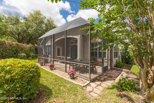 a view of a hallway to a livingroom with wooden floor and a rug