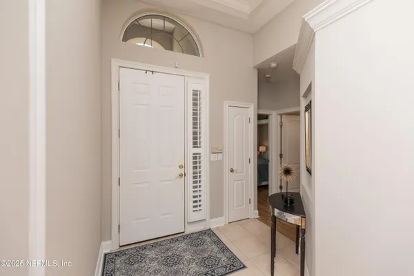 a view of a hallway with wooden floor windows and livingroom