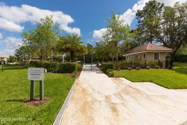 a view of house with swimming pool and yard