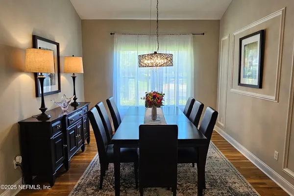 a view of a dining room with furniture and wooden floor