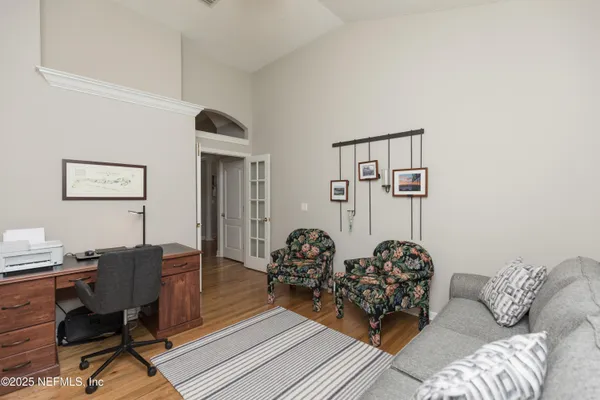 a spacious bedroom with a bed and a dresser