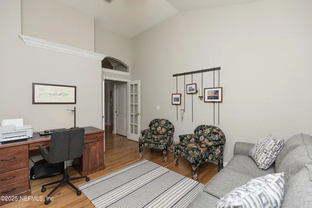 a spacious bedroom with a bed and a dresser