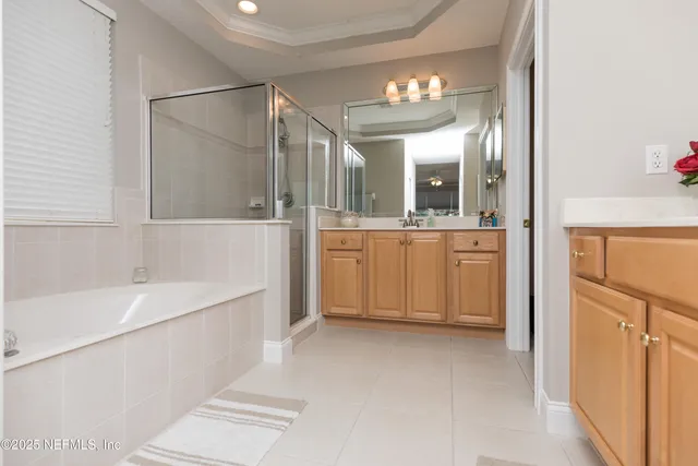 a bedroom with a bed and a lamp on dresser