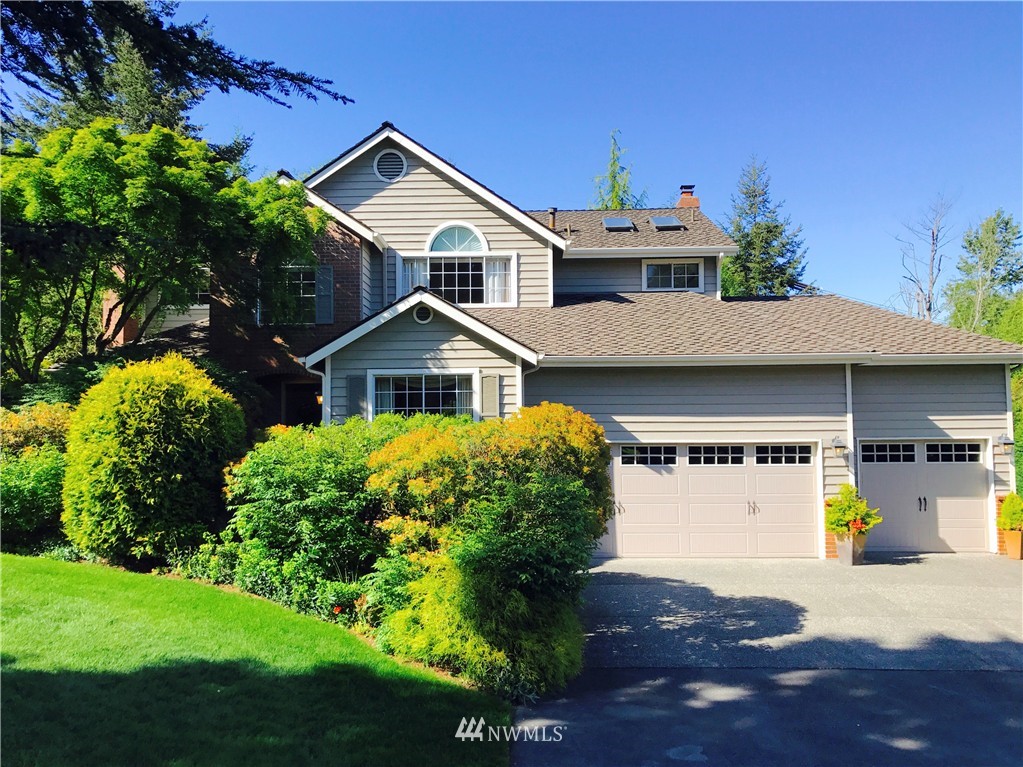 4933 211th Street Southeast Bothell, WA 98021 - Photo 1 of 25 a front view of a house with a yard