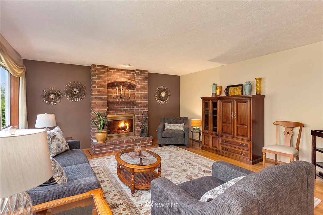 4933 211th Street Southeast Bothell, WA 98021 - Photo 6 of 25 a living room with furniture and a fireplace
