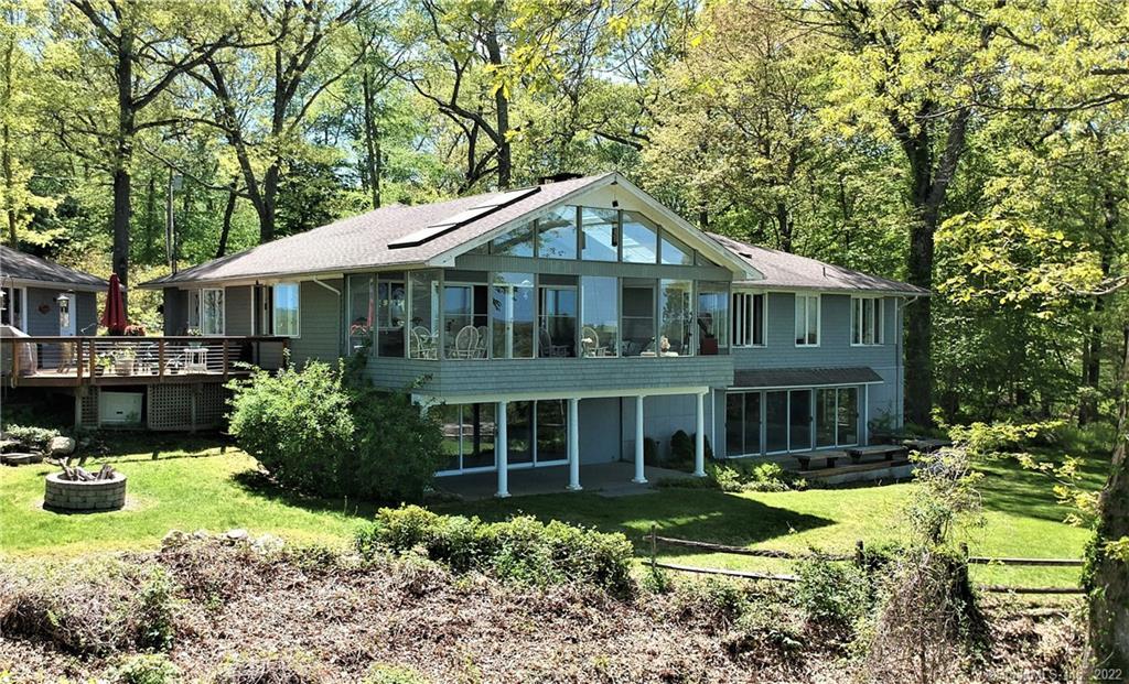 a front view of a house with a yard table and chairs