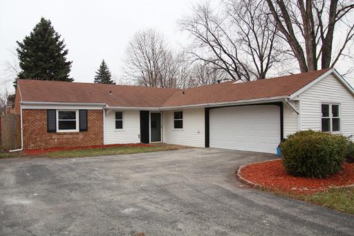 a front view of a house with a garage