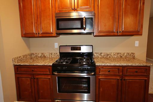 81 Seabury Road Bolingbrook, IL 60440 - Photo 2 of 10 a kitchen with granite countertop wood cabinets and stainless steel appliances