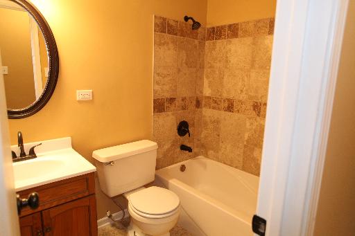 81 Seabury Road Bolingbrook, IL 60440 - Photo 4 of 10 a bathroom with a granite countertop toilet sink and mirror