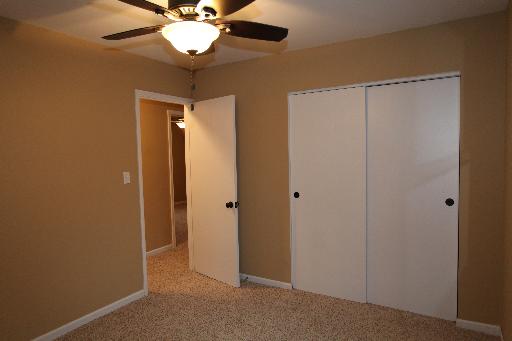 81 Seabury Road Bolingbrook, IL 60440 - Photo 7 of 10 a view of a hallway with a chandelier fan and wooden floor