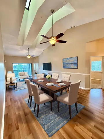 a dining room with a wooden table and chairs