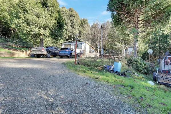 a view of a backyard with wooden fence